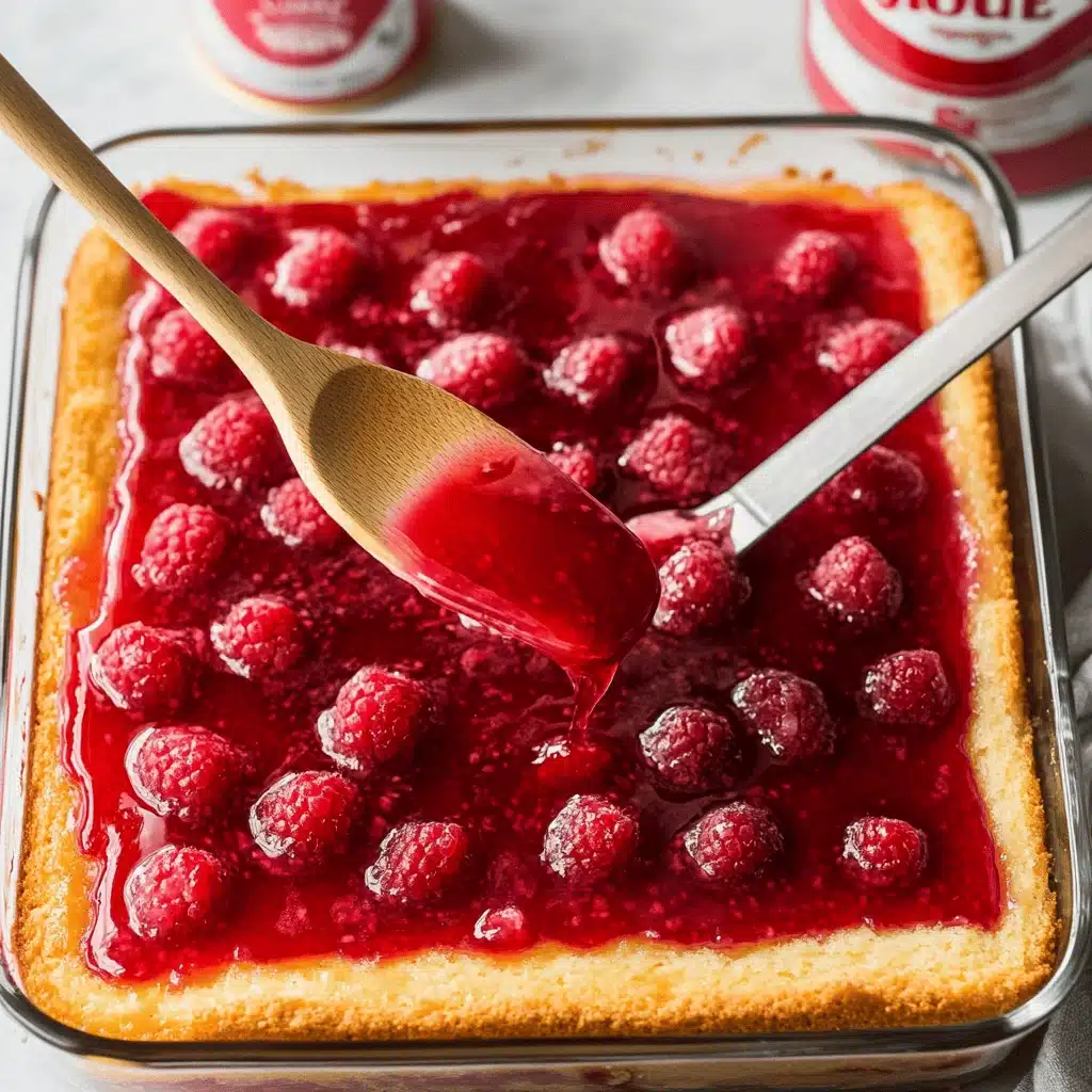 Raspberry gelatin being poured into poke holes of cake
