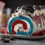 Red White & Blue Oreo Cake Roll Explosion topped with whipped cream, Oreos, blueberries, and patriotic sprinkles