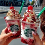 strawberry cheesecake frappuccino with whipped cream and cherry in Starbucks-style cups