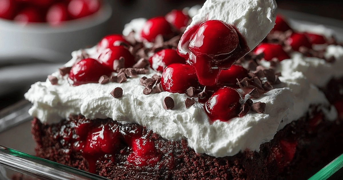  Spreading whipped topping over Black Forest poke cake