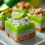 Coconut Lime Chia Pudding Bars topped with shredded coconut and lime slice on crunchy crust