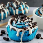 Cookie Monster cinnamon rolls topped with crushed cookies and cream cheese icing