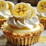 Close-up of no-bake mini banana cream pies with whipped cream, banana slices, and honey drizzle