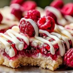 Raspberry Shortbread Cookie Bars with White Chocolate Drizzle topped with fresh raspberries