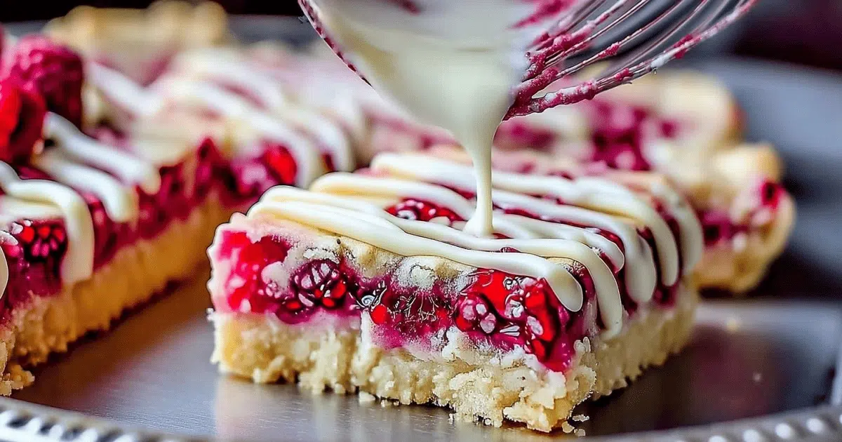 Drizzling white chocolate over raspberry shortbread cookie bars