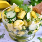Refreshing pineapple cucumber salad served in a glass bowl with lime and herbs, perfect for summer appetizers