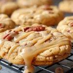 Soft maple brown sugar cookies topped with pecans and drizzled with maple glaze