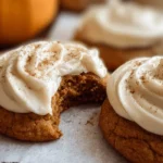 Pumpkin sugar cookies topped with cream cheese frosting and cinnamon